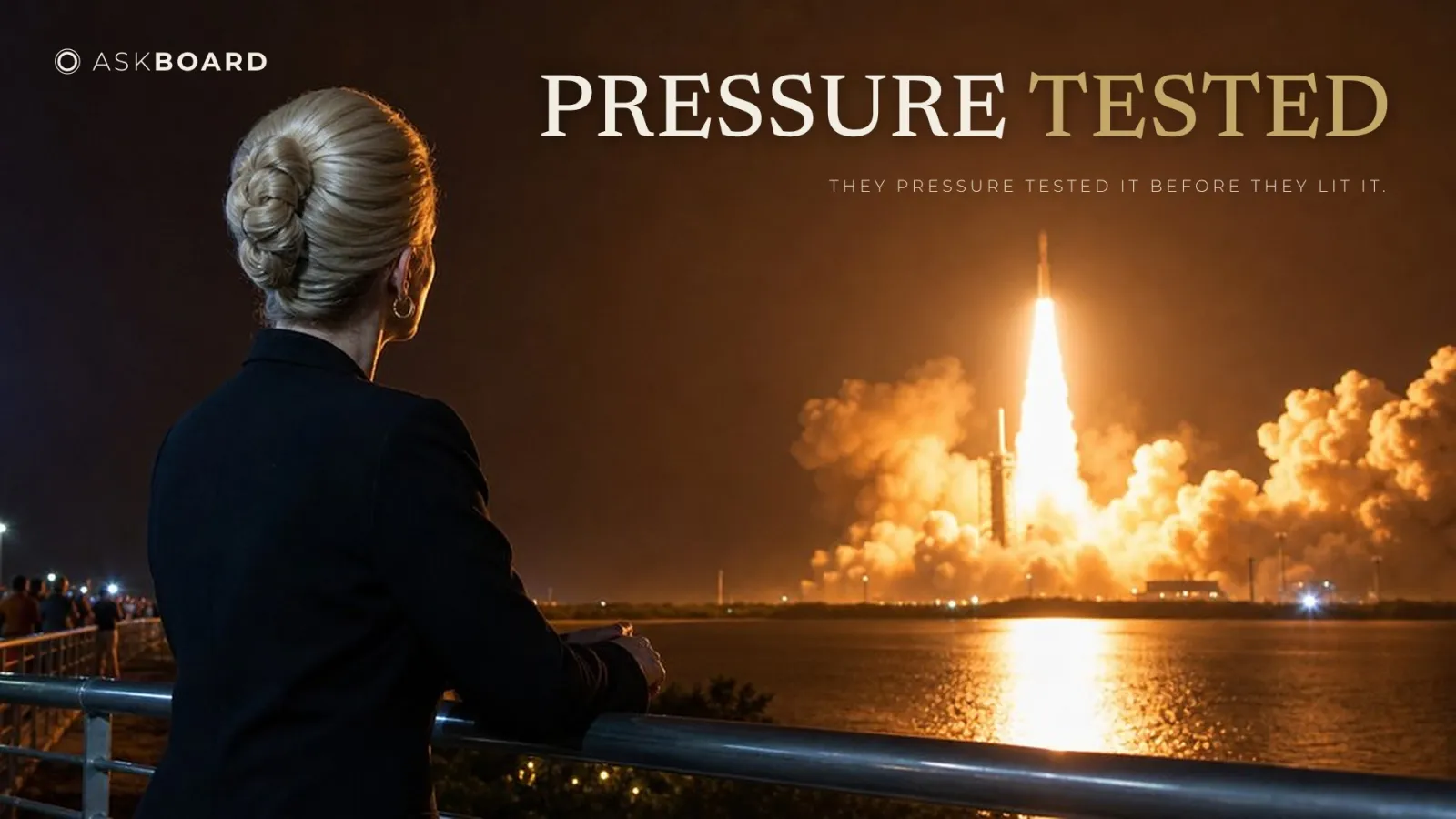 A woman in a dark suit, seen from behind at a railing, watches a rocket launch at night across the water, under the words Pressure Tested